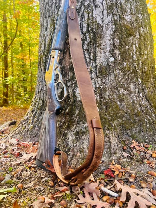 Latigo Classic Rifle Sling attached to rifle leaning against a tree